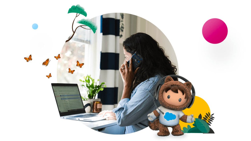 Woman sitting in front of laptop next to Salesforce character Astro wearing a headset