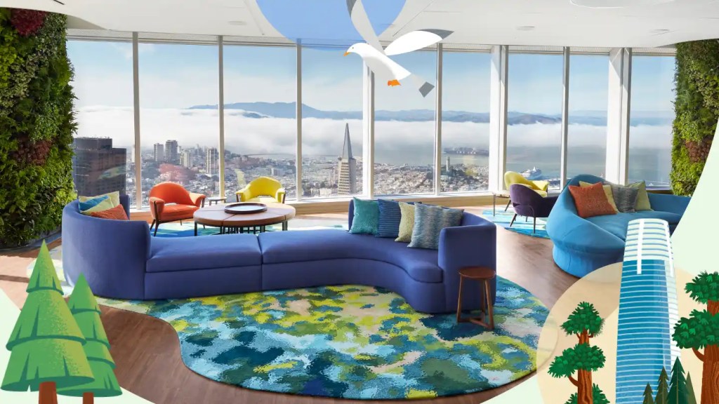 A bright blue sofa and other colorful modern decor adorn the Ohana Floor, with a sweeping view of the San Francisco bay and skyline in the background.