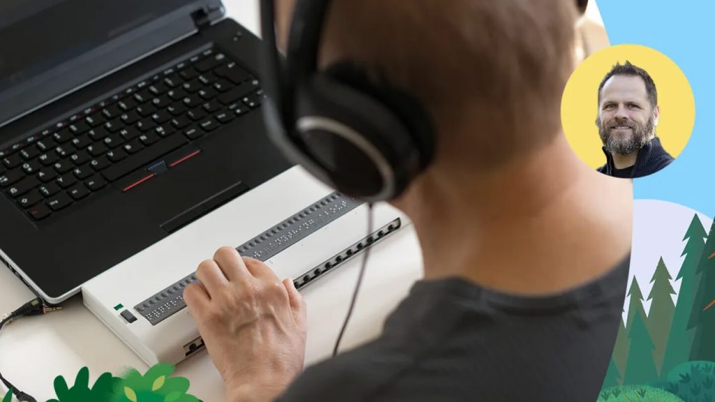 Male looking at a computer wearing headphones	
